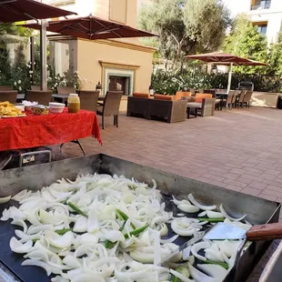 onions being cooked on a grill