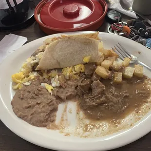 Carne Casada deep fried breakfast taters and scrambled eggs with refried beans and corn tortilla