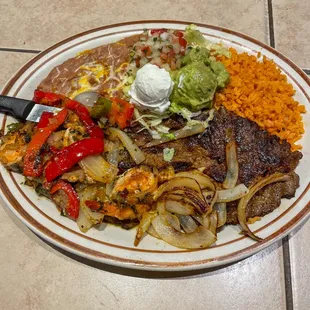 Carne Asada al mojo de Ajo served with rice and beans