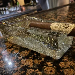 a cigar in a glass ashtray