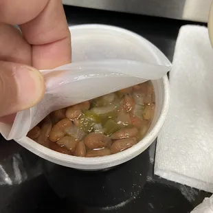 a person holding a bag of beans