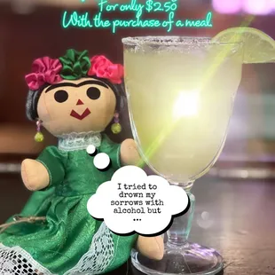a doll and a glass of margarita