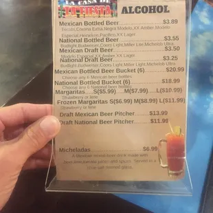 a hand holding a menu