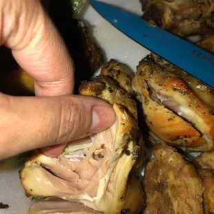 a person holding a knife over a plate of food