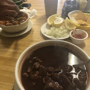 On the left is Menudo Rojo, bowl on the right is birria de res