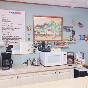 a kitchen with a counter, microwave, and coffee maker