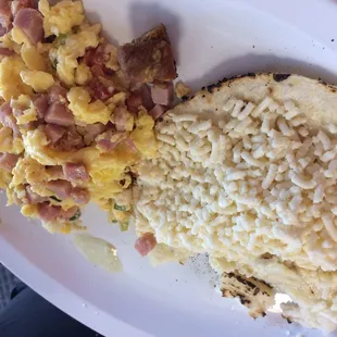 Scramble eggs with ham. And tasteless arepa and cheese