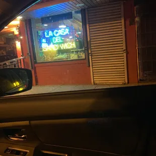 a neon sign in the window of a car