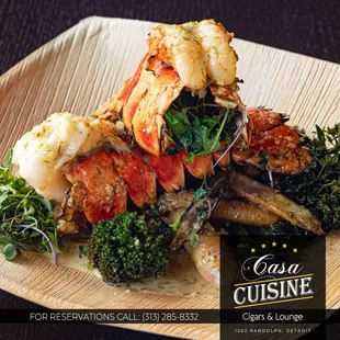 Two Baked Lobster TailS  two baked lobster tails, 6 oz. each, broccolini, rainbow carrots, with basil butter sauce