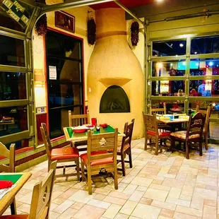 tables and chairs in front of a fireplace