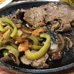 My carne asada. Medium rare. This is half devoured. The grilled peppers and onions were a perfect compliment to the tender carne asada.