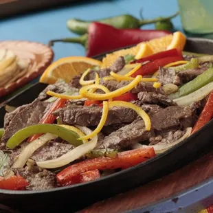 a steak and peppers in a skillet