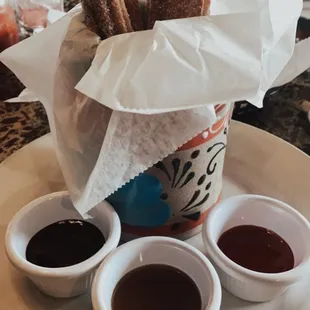 Churros with Caramel, Chocolate, and strawberry sauce