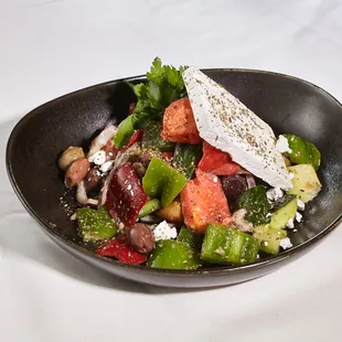 Greek Salad  Heirloom tomatoes, greenhouse cucumbers, olives, bell peppers, red onions, feta, oregano, Greek vinaigrette.