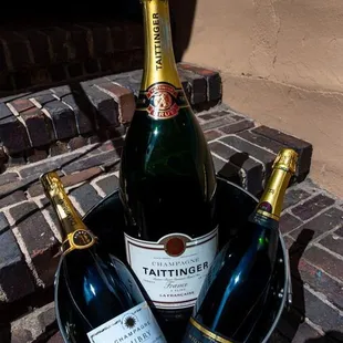 three bottles of wine in a bucket