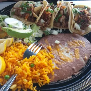 4 tacos with rice and beans   (Taco plate comes with 2 tacos, but my bf added 2 more to his order).
