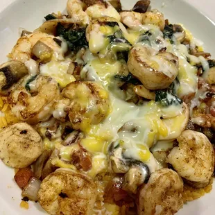 Seafood medley over rice with tomatoes, onions, and spinach.   Super delicious and perfectly done!!!!!