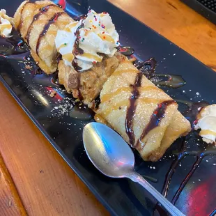 Our delicious Chango Cheesecake covered in chocolate sauce, caramel sauce, whipped cream, sprinkles, and powdered sugar!