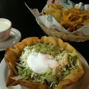 Taco salad, chips, and small cheese dip.