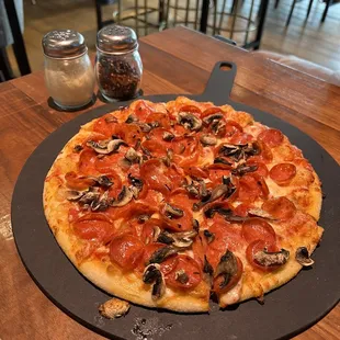 a pizza with pepperoni and mushrooms