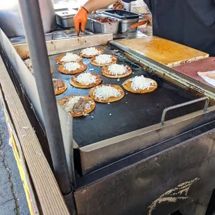 a man preparing food on a grill