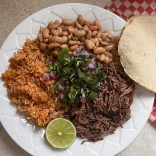 Barbacoa plate with beans, rice, and tortillas of your choice.