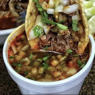 Tacos de barbacoa dipped in consomé.