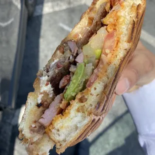 a person holding a sandwich