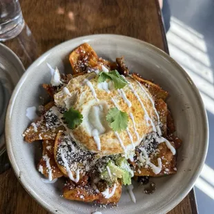 Chilaquiles, over hard eggs, with mojo pork!