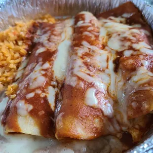 Shredded chicken enchiladas, rice, and refried beans.