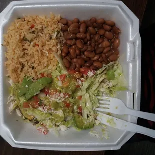 a container of rice, beans, and lettuce