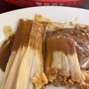 Half eaten tamales. I'll ask for more of this great sauce next time!