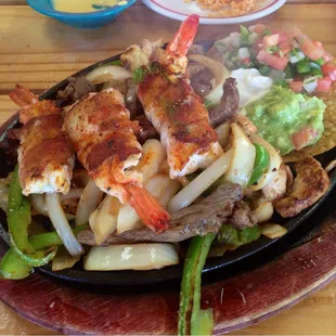 Shrimp fajitas- beef &amp; chicken w/ 3 jumbo bacon wrapped &amp; jalapeño stuffed shrimp, tortillas, rice and charro beans - $12.50