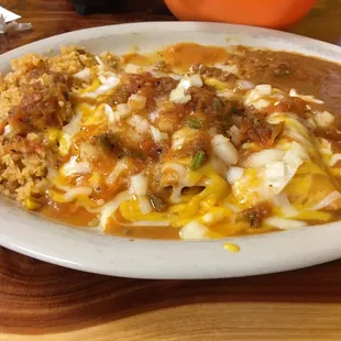 Special order of a chicken / beef &amp; cheese enchilada plate with onions.