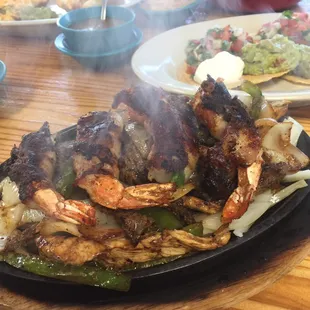 Bacon-wrapped shrimp fajitas for two with chicken &amp; beef. Comes with guacamole, pico, sour cream, rice &amp; beans.