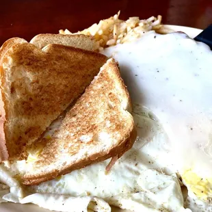 Chicken fried steak, smothered with gravy, over medium eggs, hashbrowns, and toast! Delightful!
