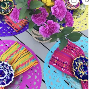 a colorful table setting with flowers