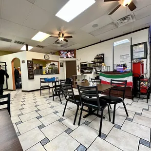 a dining area with tables and chairs