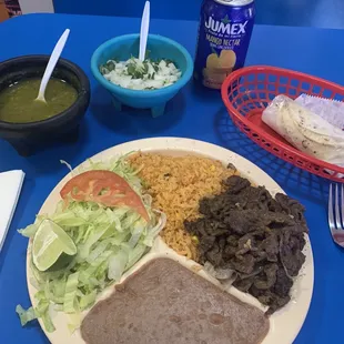 a plate of mexican food on a blue table