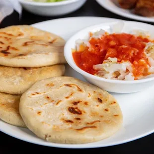 a plate of flatbreads and a bowl of salsa