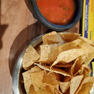 a bowl of chips and a bowl of salsa