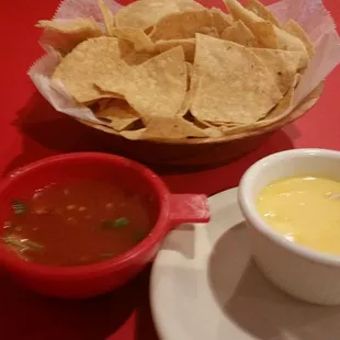 Complimentary, warm salsa, queso and chips