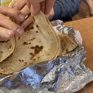 Three of these enormous meat, avocado, and bean filled tortillas