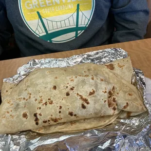 Some kind of homemade tortilla stuffed with red beans,  avocado, &amp; beef.  Massive amount of food!