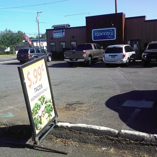 The sign for the tacos is placed in front of Rocco's, probably for visibility from S.E. 82nd, but it's the food truck that serves them.