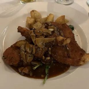 Chicken cutlets lightly fried over fresh spinach and potatoes with a nice brown sauce. Mushrooms as well.