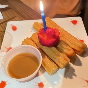 strawberries and a candle on a plate