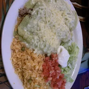 Enchiladas suizas - tender and juicy Pulled pork wrapped in a corn tortilla and covered in a mild sauce