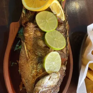 a fish with limes and chips