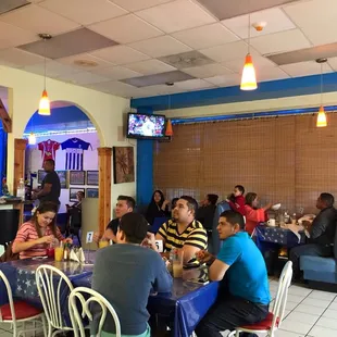 people sitting at tables in a restaurant